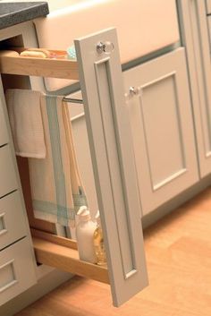 an open cabinet in the middle of a kitchen