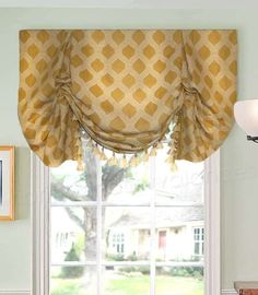 a kitchen window with yellow and white curtains