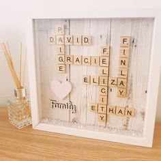 a scrabble frame with the word love spelled in it and a toothbrush holder next to it