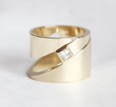 two gold wedding bands with diamonds on them