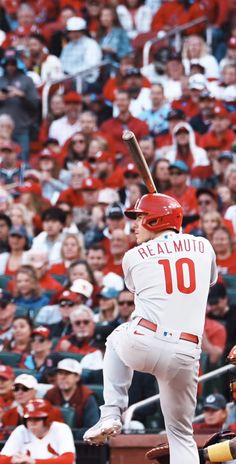 a baseball player is getting ready to swing at the ball while fans watch from the stands