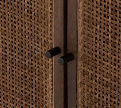 a close up of a wooden door with metal handles