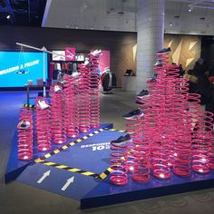 a bunch of pink cups sitting on top of a blue platform