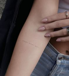 a woman's arm with a small tattoo that reads, i am not sorry