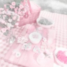 a pink picnic table with flowers and plates