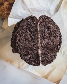 a piece of chocolate cake sitting on top of paper