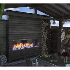 an outdoor fireplace in the middle of a patio