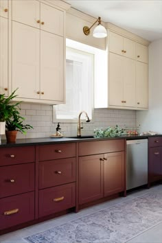 English style traditional red kitchen renovation. Shaker doors, black kitchen countertop, brass cup pulls, brass knobs, white subway tile, red kitchen cabinets paired with a creamy white. Terracotta White Kitchen, Deep Red Kitchen Cabinets, Dark Red Cabinets, Red Countertop Kitchen, Dark Red Kitchen Cabinets, Terracotta Cabinets, Deep Red Kitchen, Burgundy Kitchen Cabinets, Terracotta Kitchen Cabinets