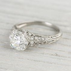 an antique style diamond ring with filigrees