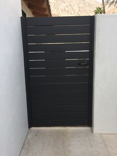 a black and white gate in front of a house