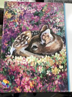 a painting of two fawns laying in flowers