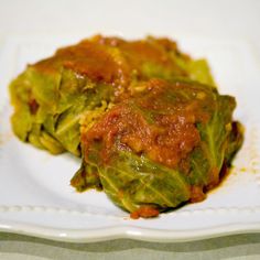 cabbage covered in sauce on a white plate