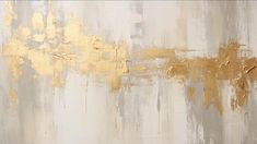 an abstract painting with gold paint on it's side and white wall behind it