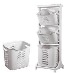 three white baskets are stacked on top of each other next to a shelf with four bins