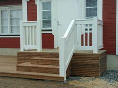 a red and white house with steps leading up to the front door