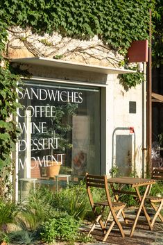 there is a sign that says sandwhiches coffee and dessert moment in the window