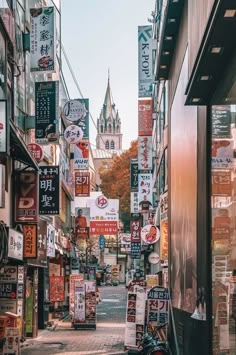 an alley way with many signs and buildings in the background