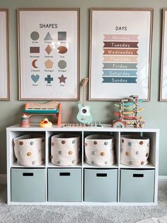 a room filled with lots of toys and pictures on the wall above it's storage bins