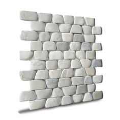 a white wall made out of small rocks