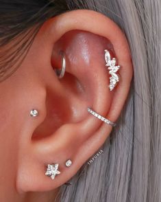 a close up of a person with ear piercings on their ears and behind the ear