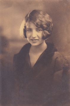 an old black and white photo of a woman