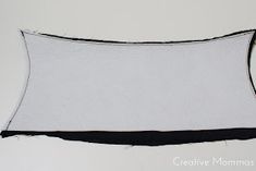 a white and black pillow sitting on top of a table