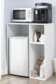 a microwave oven sitting on top of a white shelf