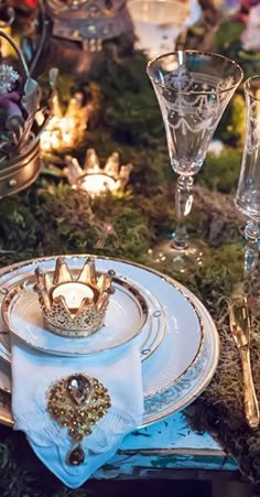 the table is set with silver and white dishes