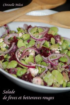 a salad with red onions and celery in a white bowl on a table