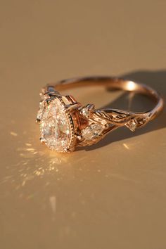 a close up of a diamond ring on a gold surface with light shining through it