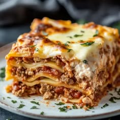 a close up of a plate of lasagna with meat and cheese on it