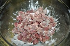 raw meat in a glass bowl on top of a stove