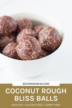 coconut rough bliss balls in a white bowl on a marble counter top with text overlay