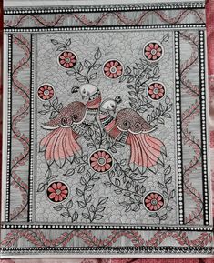 two birds sitting on top of a red and white cloth