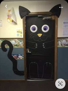 a door decorated to look like a black cat