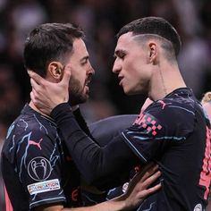 two soccer players are embracing each other