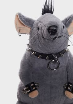 a stuffed rat with spikes on it's back legs and ears, sitting in front of a white background