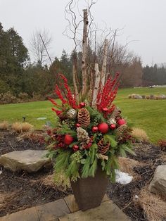 a planter filled with red and green christmas decorations