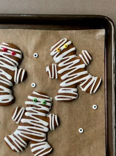 several decorated ginger cookies on a baking sheet