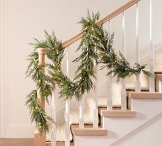 christmas garland hanging on the banister and stairs