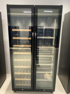 two glass door refrigerators sitting next to each other