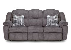 the reclining sofa has two pillows on it and is grey with black and white plaid