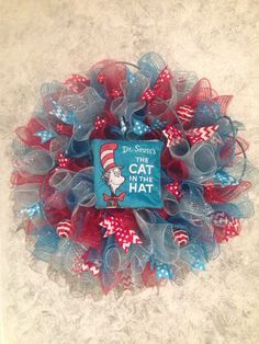 a cat in the hat wreath with red, white and blue mesh bows on it