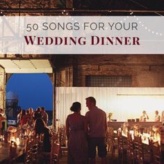 a couple standing next to each other in front of a table with candles on it