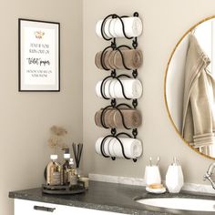 a bathroom with a sink, mirror and towel rack