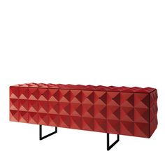 a red sideboard with black legs and an abstract design on the front, against a white background