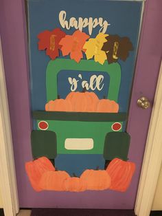 a door decorated to look like a truck with pumpkins and leaves on the front