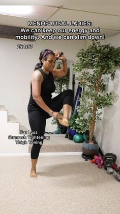 a woman in black shirt and leggings doing yoga