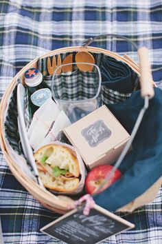 a picnic basket filled with food and drinks