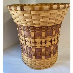 a woven basket is sitting on a white surface